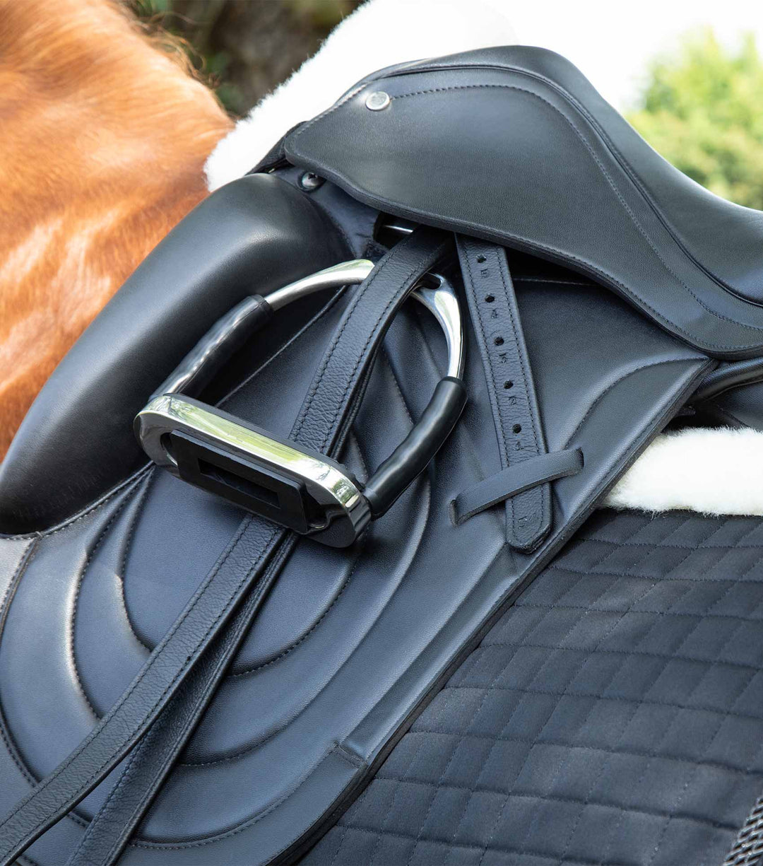 Premier Equine Stainless Steel Flei Stirrup - on saddle close up